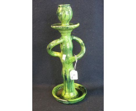 Ewenny pottery style candlestick on a green glazed ground with wrythen handles and circular base, height 37cm approx. Unmarke