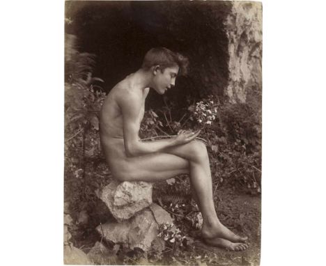   Gloeden, Wilhelm von: Young male nude contemplating flower  Young male nude contemplating flower. Circa 1900. Albumen print