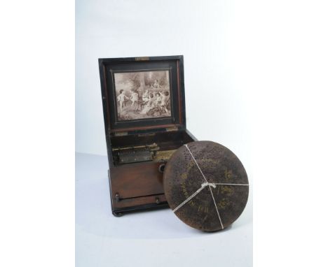 A Late 19th Century mahogany cased Schutz Marke German  polyphon
The hinged cover revealing interior brass fittings and name 