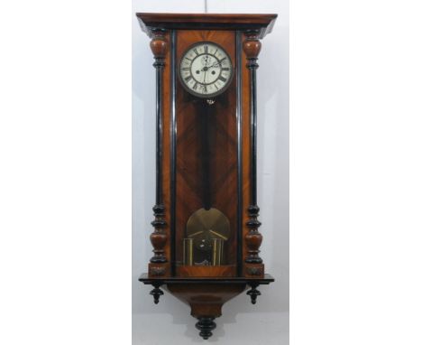 A Victorian mahogany and ebonised Vienna wall clock
The architectural case with hinged door, tapered and turned apron, the ve