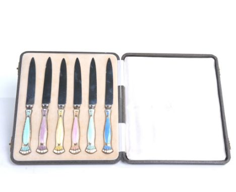 An Art Deco set of six silver-glit and enamel dessert knives by Turner &amp; Simpson Ltd., Birmingham 1934
In a variety of co