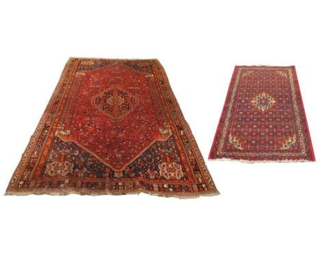 Two Middle Eastern rugs
The first a Persian medallion style rug on a predominantly red ground with central lotus medallion lo