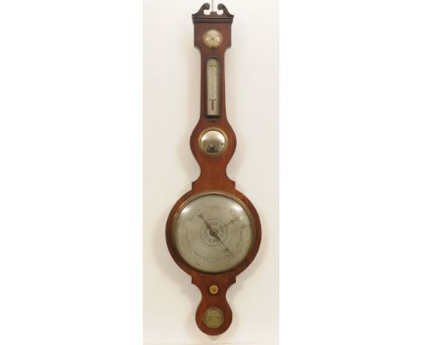 An early 20th Century mahogany cased wheel barometer
With a 25cm silvered register above a hygrometer, thermometer, mirror an