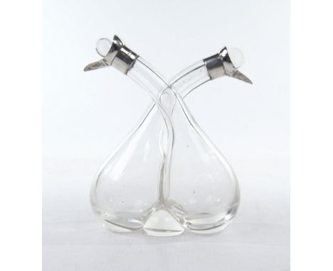 A set of silver mounted twin oil bottles, by BP, London 1913
The glass bottles intertwined, crossing at the neck, with silver