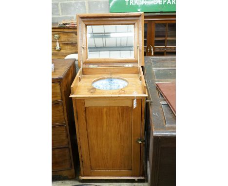 A late Victorian pitch pine wash stand with mirrored folding lid and blue and white printed basin (a.f.), width 58cm