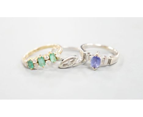 A 750 yellow metal, threes tone emerald and six stone diamond chip set half hoop ring, size L, a 750 white metal and tanzanit