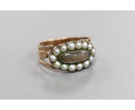 A George III yellow metal, seed pearl and plaited hair beneath a rock crystal? panel set mourning ring, inscribed, 'Maria Win