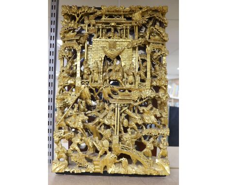 A large Chinese carved giltwood panel, 65 x 40cm