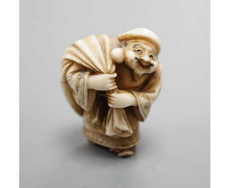 A Japanese ivory netsuke of Daikoku or Ebisu, Meiji period,4 cms high.