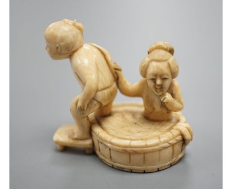 A Japanese ivory Netsuke of a bathing couple, Meiji period,3.5 cms high.