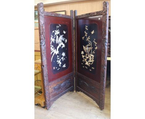 A Japanese shibayama work two fold screen, each panel with oblong reserve depicting a bird of prey on a flowering branch, a b