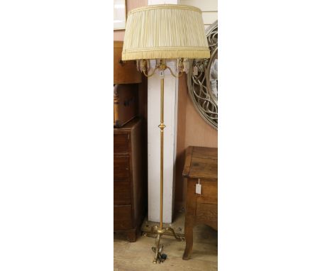 A gilt standard lamp with cherubs Width of base 36cm