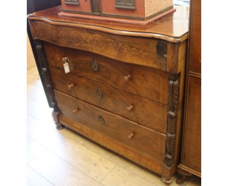 A Spanish inlaid walnut commode, mid-19th century, of serpentine form with shaped frieze drawer over three long drawers, flan