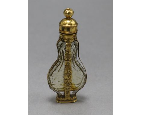 A late 18th century French yellow metal mounted glass scent bottle, with pierced removable finial, the base engraved " E G Al