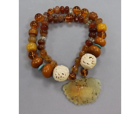 A string of assorted mixed beads with pierced jade wu fu pendant and dual pierced carved ivory balls, one with fish, the othe
