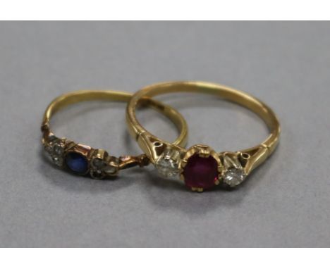 An 18ct gold, ruby and diamond three stone ring and a smaller 18ct gold, sapphire and diamond ring.