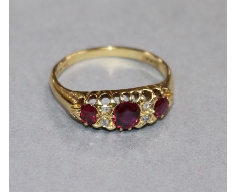 An early 20th century 18ct gold, ruby and diamond half hoop ring, size Q.