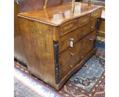 A Spanish inlaid walnut commode, mid-19th century of serpentine form, fitted shaped frieze drawer over three long drawers wit