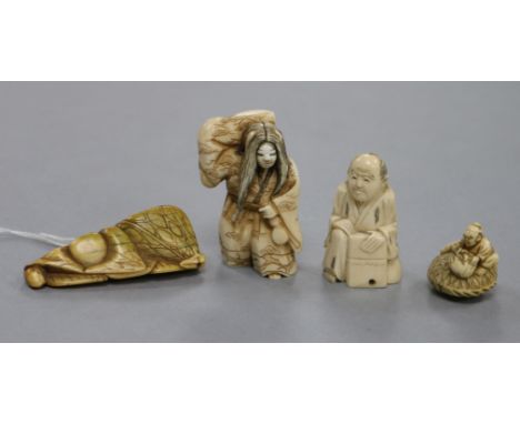 A Japanese carved ivory netsuke of a woman carrying a bundle, a netsuke formed of stylised fruit and leaves and two others (4