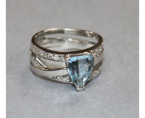 A modern 18ct white gold, aquamarine and diamond set dress ring, size K.