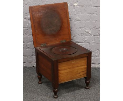 A Victorian mahogany commode raised on turned feet.  