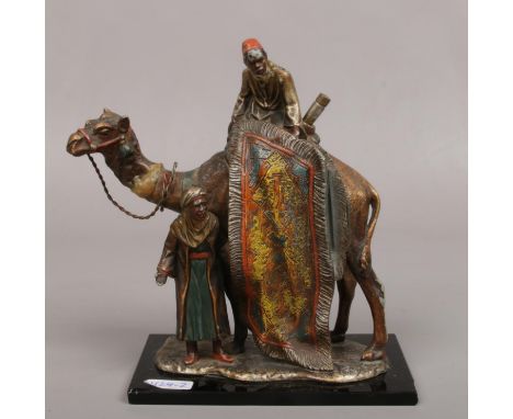 After Franz Bergman, a cold painted Spelter table lighter formed as a camel and two rug sellers.  Repair to neck.