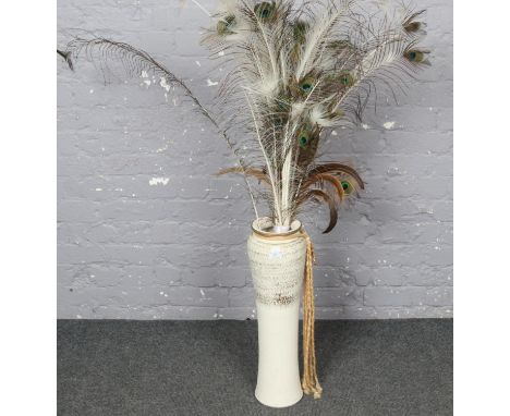 A Large ceramic vase (61cm High 15cm wide) with peacock feathers  