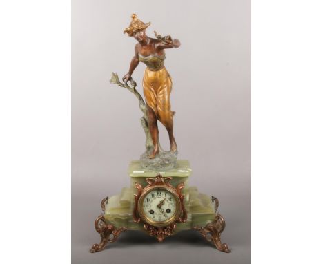 A French Art Nouveau onyx mantle clock, with arabic numeral markers, surmounted with a spelter figure of a maiden (the base i