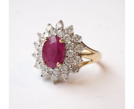 RUBY AND DIAMOND CLUSTER DRESS RING
the central oval cut ruby approximately 1ct in double diamond surround totalling approxim