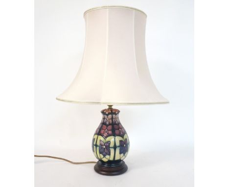 MOORCROFT 'VIOLET' PATTERN POTTERY TABLE LAMP
designed by Sally Tuffin, raised on circular base, the lamp approximately 20.5c