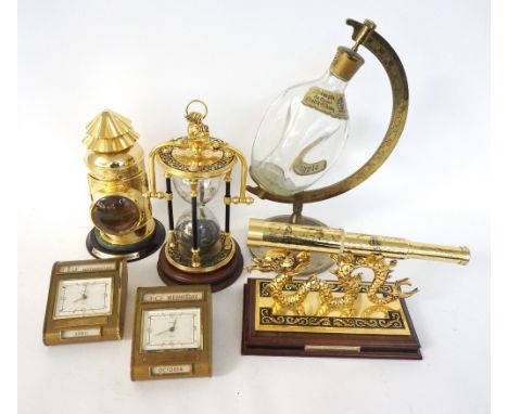 BRASS MARITIME HOUR GLASS
with decorative panels to the glass, contained in a rotating case with a dolphin finial hanging loo