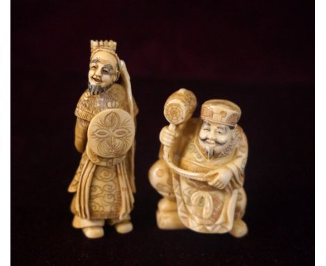 JAPANESE CARVED IVORY NETSUKE
of the deity Daikoku, 5cm high; and an ivory netsuke of a Samurai warrior with his bow and arro