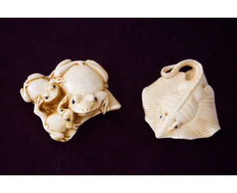 JAPANESE CARVED IVORY NETSUKE
of a stingray, signed, 4.8cm long; and an ivory netsuke of three frogs, signed, 4.6cm long (2)