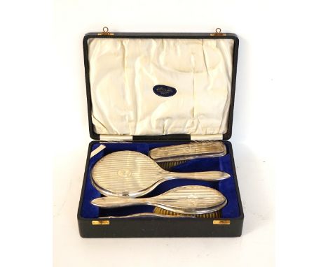 GEORGE V SILVER DRESSING TABLE SET
comprising mirror, comb and two brushes, Birmingham marks, with fitted case retailed for '