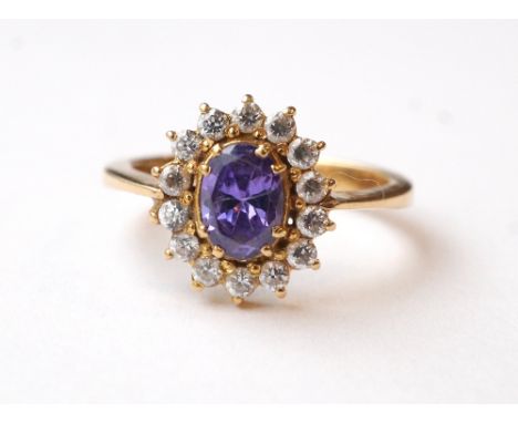 AMETHYST AND WHITE SAPPHIRE CLUSTER RING
on twenty-two carat gold shank, the central oval cut amethyst in fourteen sapphire s