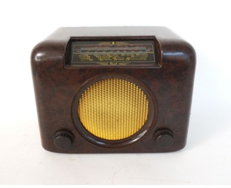 1950's BUSH BAKELITE RADIO TYPE D.A.C.90A
in a simulated walnut case with an angled wave band indicator above a circular cent