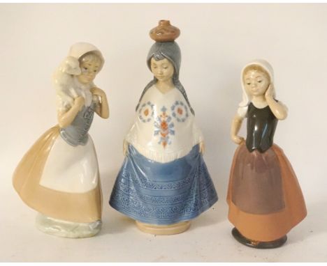 THREE NAO/LLADRO GIRL FIGURES
a native American girl with water pot balanced on her head, 27.5cm high; a girl holding a lamb 