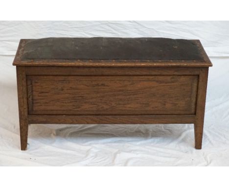 VINTAGE OAK HALL BENCH
with a padded lift up lid above a panelled body, standing on shaped supports, 92cm wide 