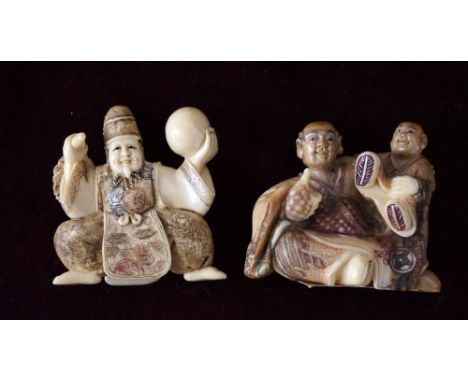 CARVED IVORY NETSUKE
of a man seated with a boy on his shoulder, 3.5cm high; and a carved ivory netsuke of a performer holdin