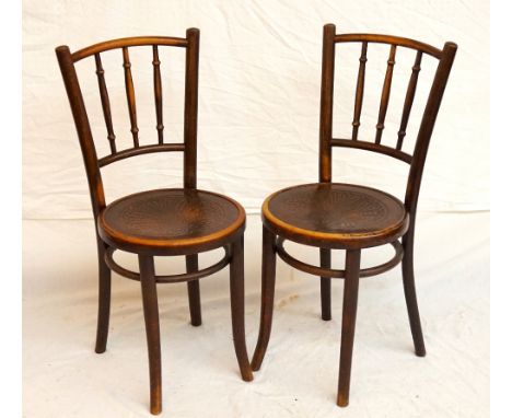 PAIR OF BENTWOOD CHAIRS
with a turned stick back above a circular patterned seat, standing on shaped supports, both bearing a