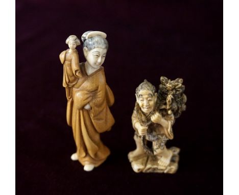 JAPANESE CARVED IVORY NETSUKE
of a lady with a puppet, signed, 7.6cm high; and an ivory netsuke of a man with a basket full o