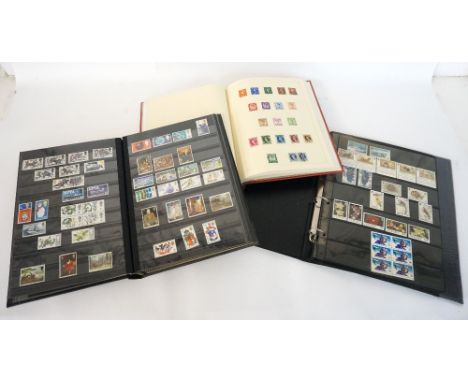 THREE STAMP ALBUMS
containing British, Commonwealth and world stamps, including the 1948 Olympic games, Festival of Britain a