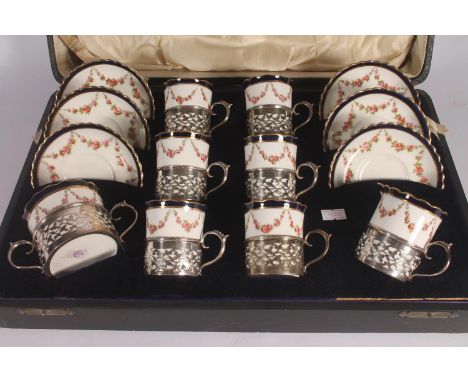 George Jones crescent china coffee set for six, early 20th century, the porcelain decorated with gilt and cobalt rims over ro