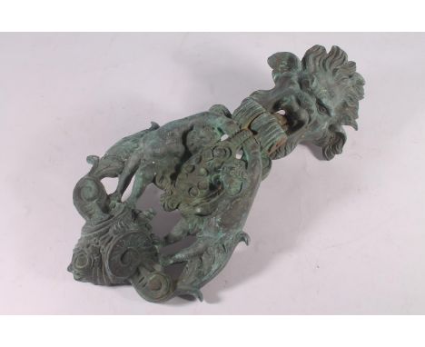Renaissance revival cast metal door knocker, the mask head fixing plate over a hinged hammer decorated with twin cherubs, she