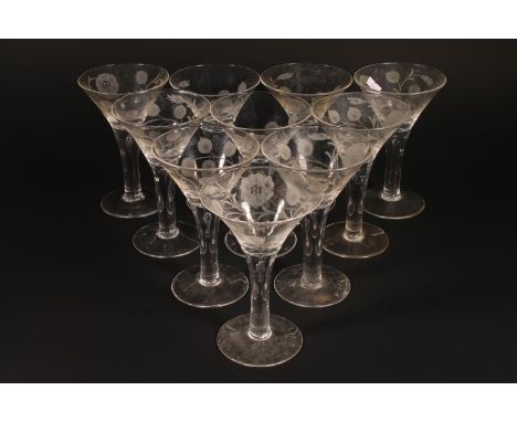 A set of ten Jacobean themed wine glasses, of wide trumpet form, tapering to a stem with inverted teardrop inclusion, on plai