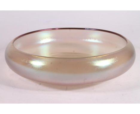 In the manner of Steuben or WMF Myra; an iridescent glass bowl, c1910, of plain form with inverted rim, W28.5cm.
