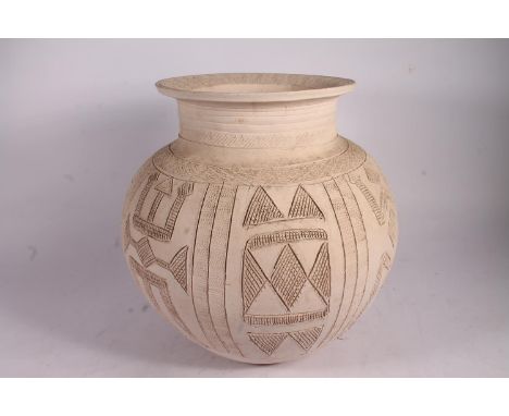 Ladi Kwali (Nigerian 1925-1984); An Abuja biscuit ware studio pottery grain pot, of large proportions, the unglazed body sgra