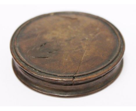 An old treen snuff box, label inside '…box was made… …a monk's coffin taken from Furness Abbey about the year…', diam. 6.6cm