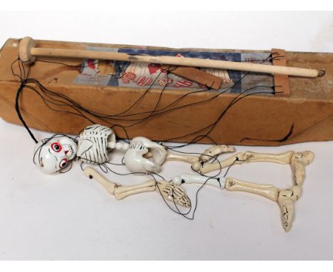 A Pelham skeleton puppet. Condition - possibly partly repainted?, wear to box.