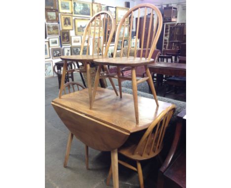 An Ercol light elm and beech table and four chairs